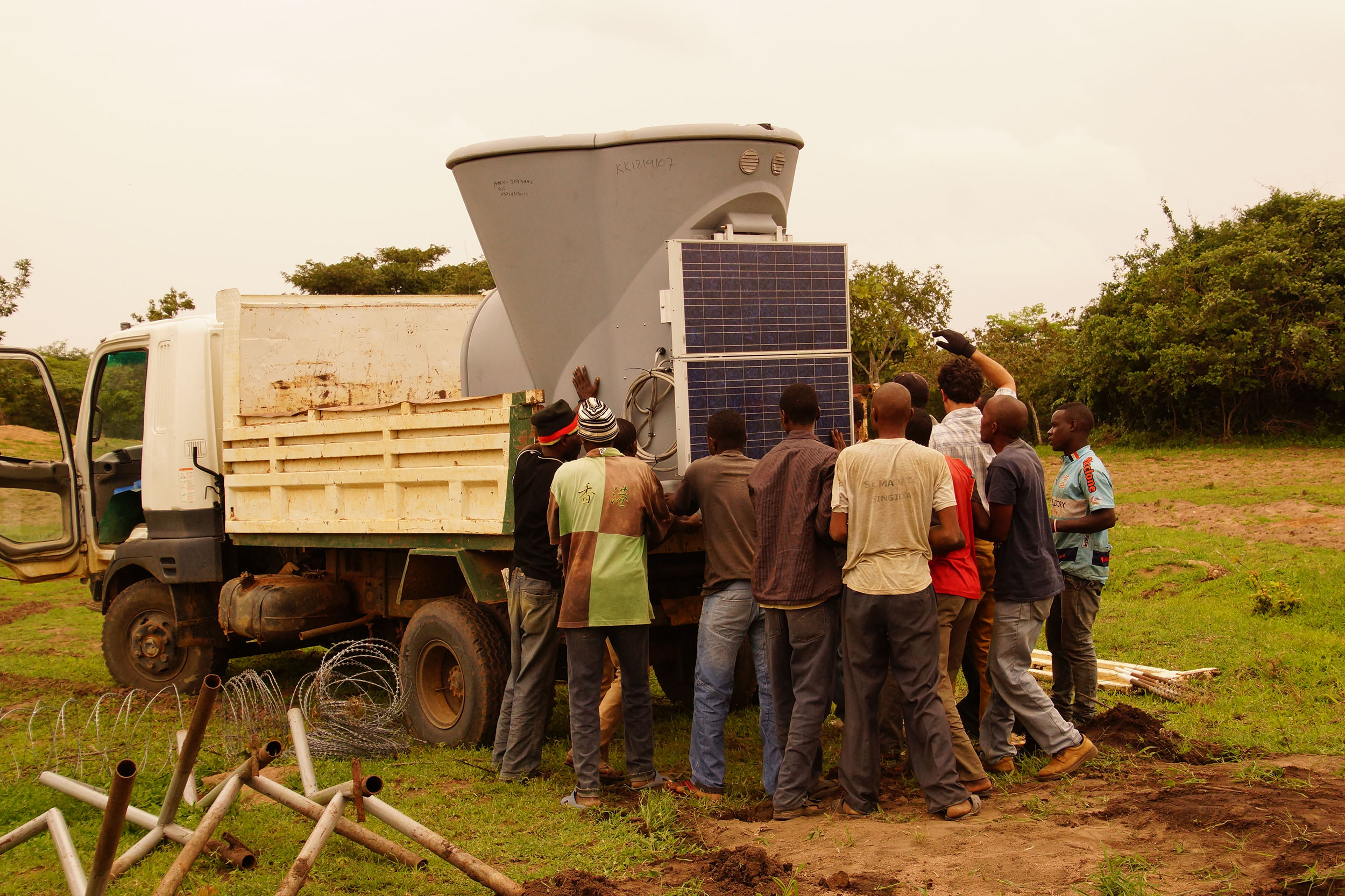 The team loads a SODAR unit and its solar panel onto a truck to move it to another location. The two SODAR units on site are moved periodically to provide additional wind data from multiple locations across wind farm site.