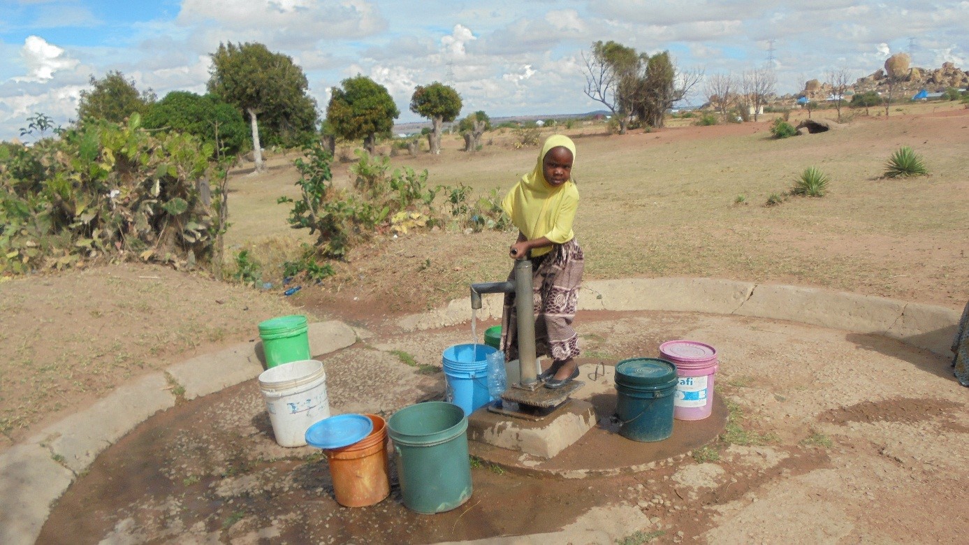 A local girl gathers clean water from an improved water source.