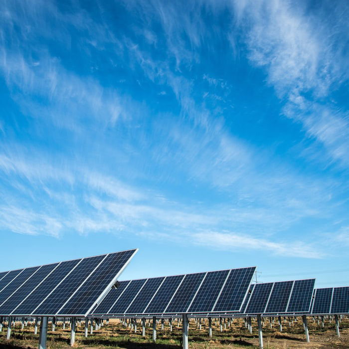 Field of solar panels with a blue sky